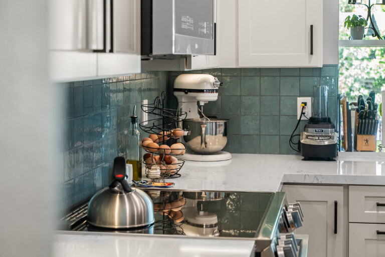 Teal Tile Detail Beside the Cooktop with a glazed teal tile backsplash in Thousand Oaks by RnD Builders Inc