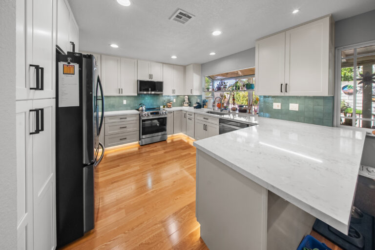 Peninsula View with Tall Pantry Cabinets with a white countertop peninsula in Thousand Oaks by RnD Builders Inc