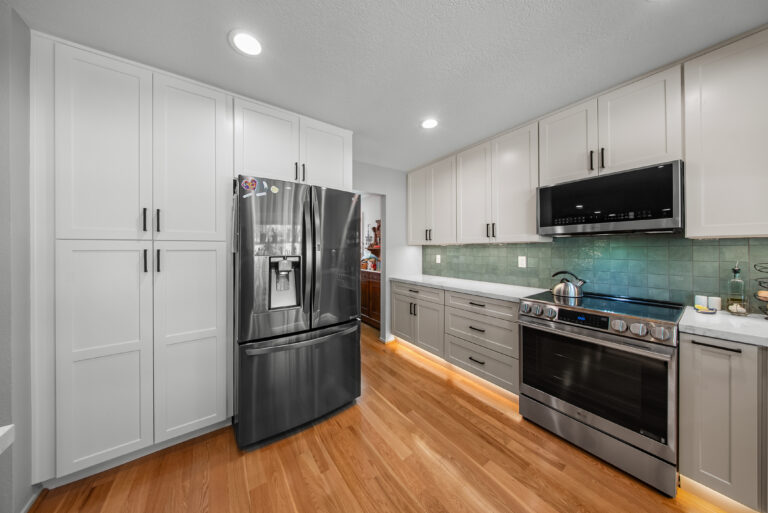 Tall Pantry Cabinets and Refrigerator Wall with tall white shaker pantry cabinets in Thousand Oaks by RnD Builders Inc