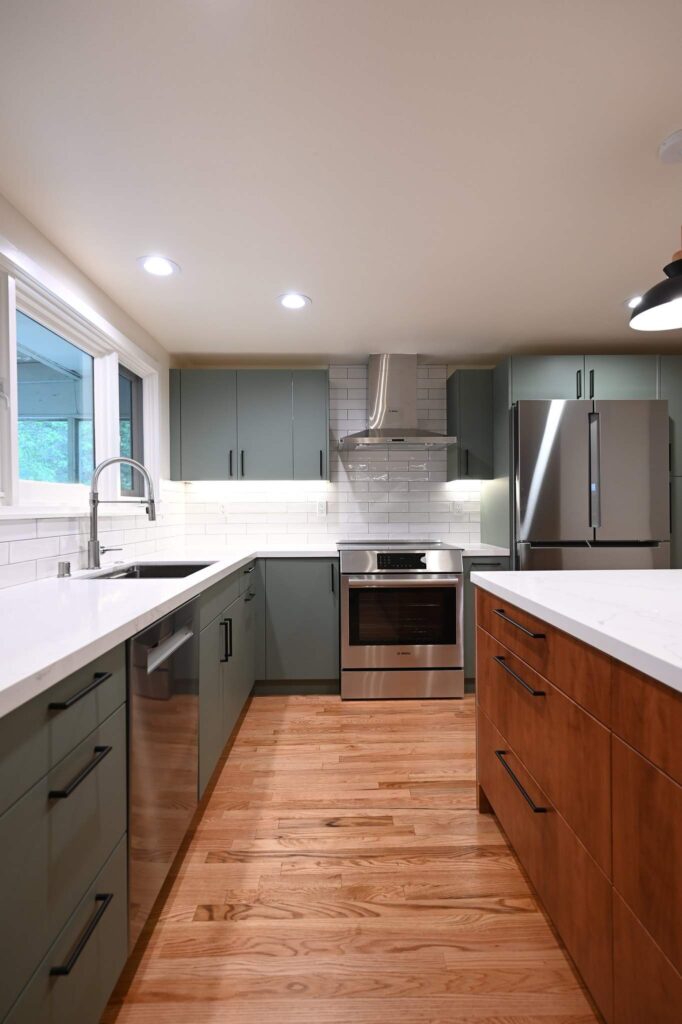 Thousand Oaks green kitchen: Modern kitchen remodel with sage green flat-front cabinets, stainless Bosch appliances, and white quartz countertops in Thousand Oaks by RnD Builders Inc