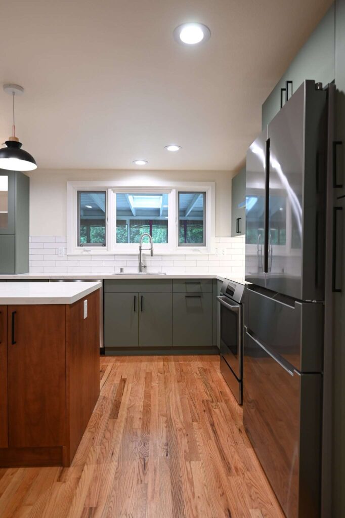 Thousand oaks kitchen remodels Kitchen remodel with sage green flat-front cabinets, white quartz countertops, and hardwood floors in Thousand Oaks by RnD Builders Inc