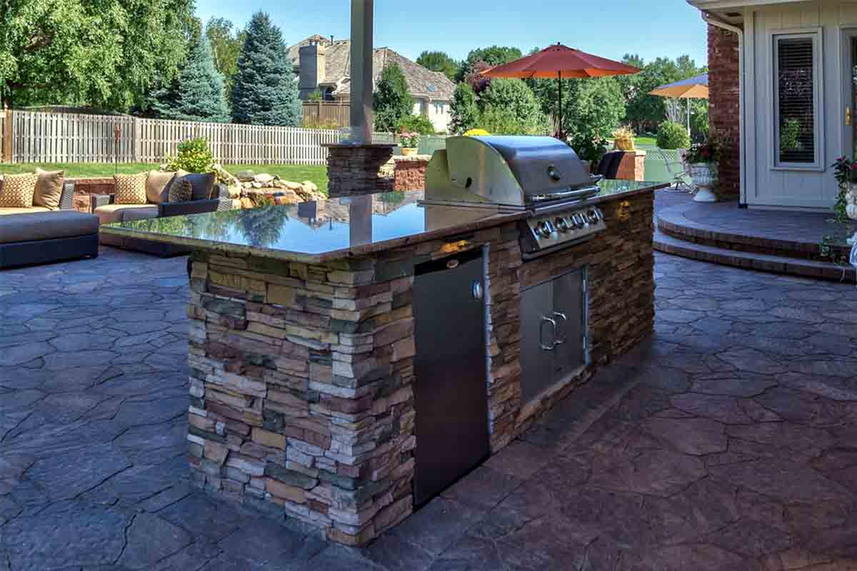 concrete block outdoor kitchen being waterproofed with sealant