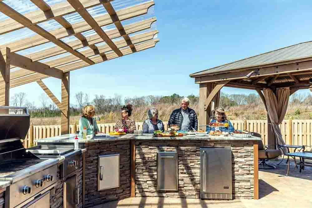 L-shaped outdoor kitchen layout with grill, countertops, and seating area